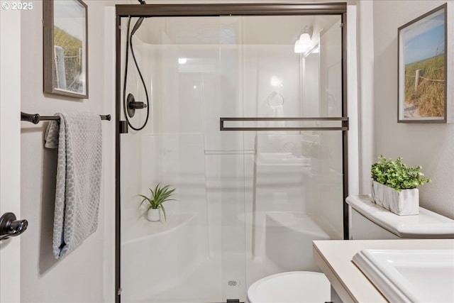 bathroom featuring walk in shower, vanity, and toilet