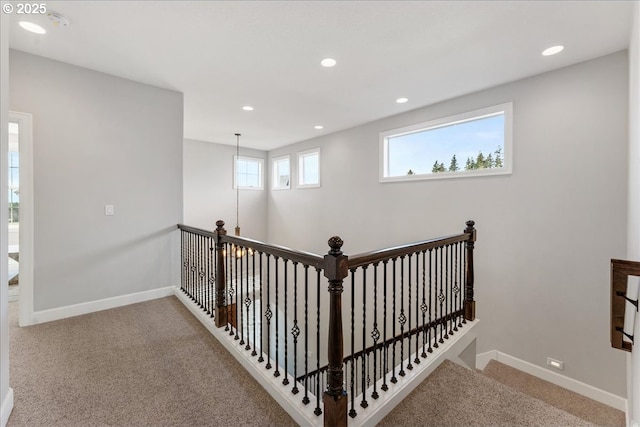 stairway featuring carpet