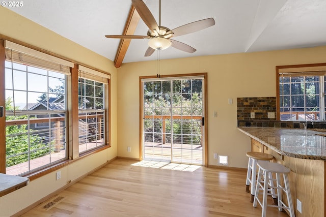 doorway featuring a wealth of natural light, a ceiling fan, light wood-type flooring, and visible vents