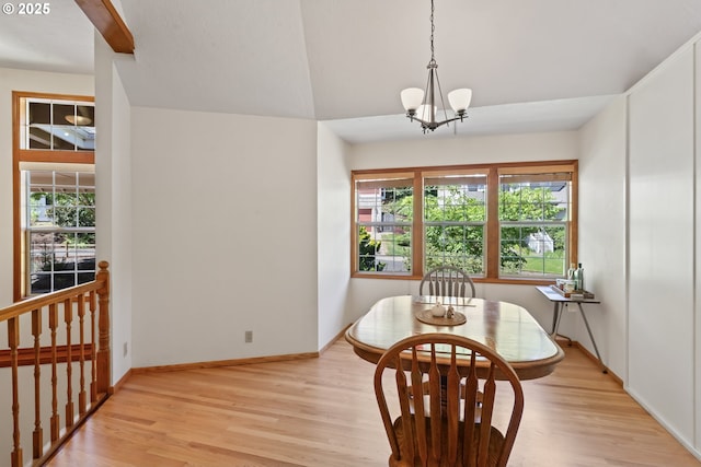 dining space featuring light wood-style floors, plenty of natural light, and a notable chandelier