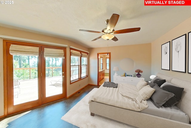 bedroom featuring visible vents, wood finished floors, baseboards, access to outside, and ensuite bath
