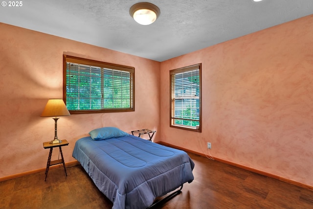 bedroom featuring baseboards and wood finished floors