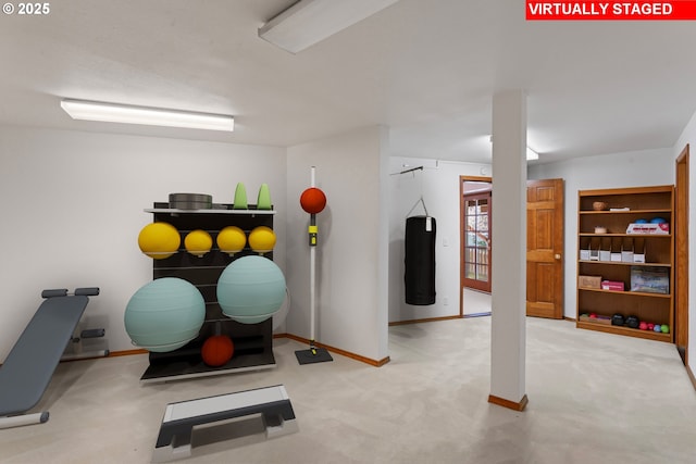 workout room with baseboards and carpet flooring