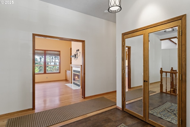 interior space featuring baseboards and wood finished floors