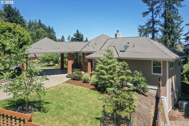 view of front of home featuring a shingled roof, a front yard, a chimney, and cooling unit