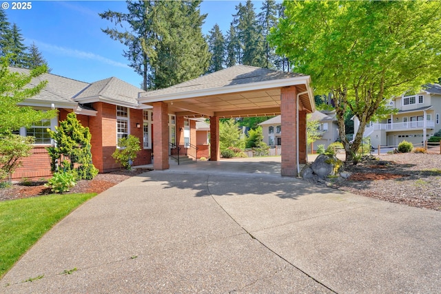 view of home's community with concrete driveway and a carport