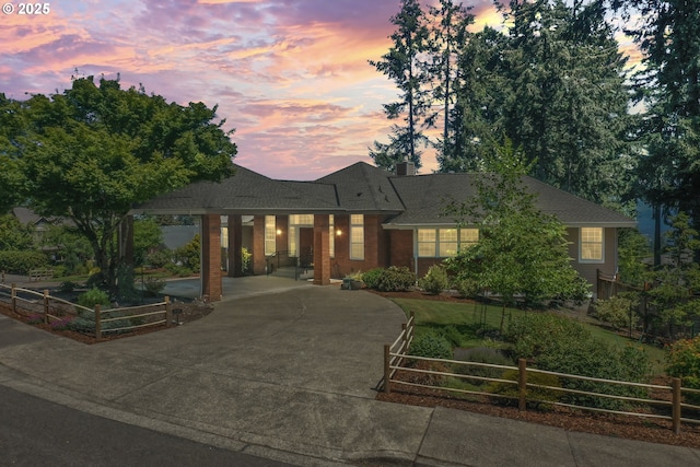 view of front facade featuring fence and driveway