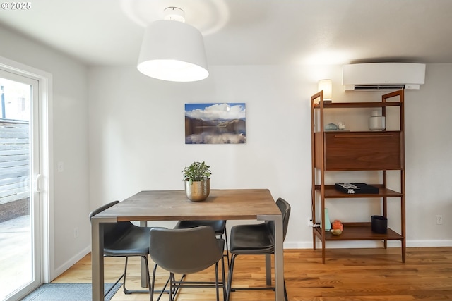 109 NE Shaver Ave, Portland, OR 97212 - dining space with a wall mounted AC, wood finished floors, and baseboards
