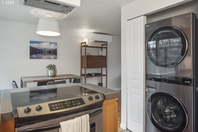109 NE Shaver Ave, Portland, OR 97212 - laundry area featuring stacked washing machine and dryer and an AC wall unit
