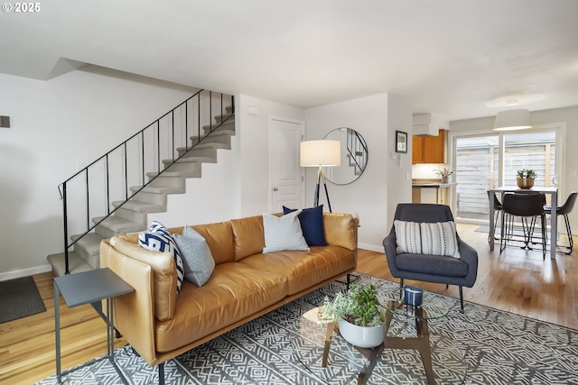 109 NE Shaver Ave, Portland, OR 97212 - living area with stairs, light wood-style flooring, and baseboards