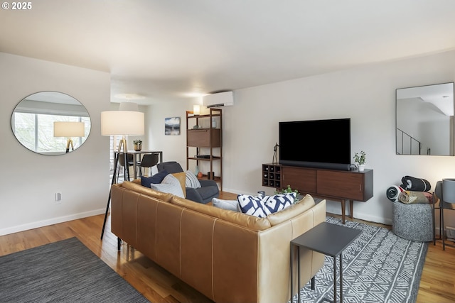 109 NE Shaver Ave, Portland, OR 97212 - living room with a wall mounted air conditioner, wood finished floors, and baseboards