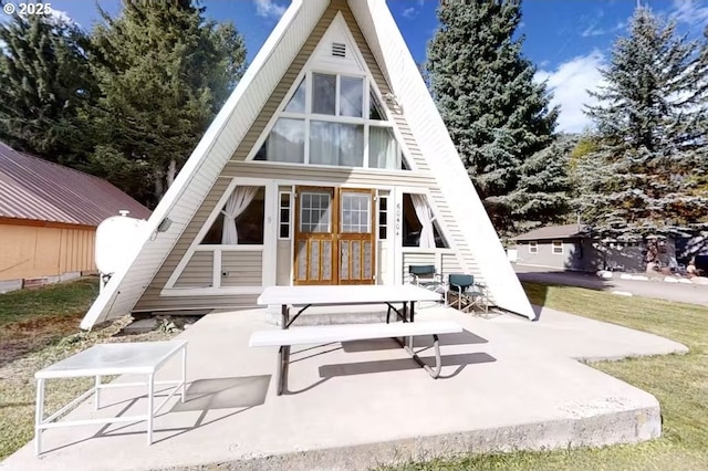 back of property featuring a patio and french doors