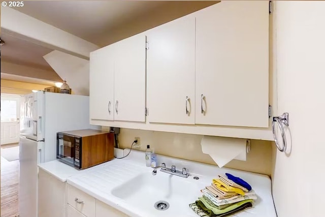 kitchen with sink and white cabinets