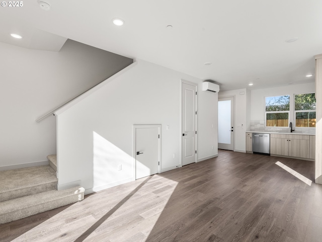 688 SE 47th Ave, Portland, OR 97215 - unfurnished living room with recessed lighting, an AC wall unit, stairway, and wood finished floors