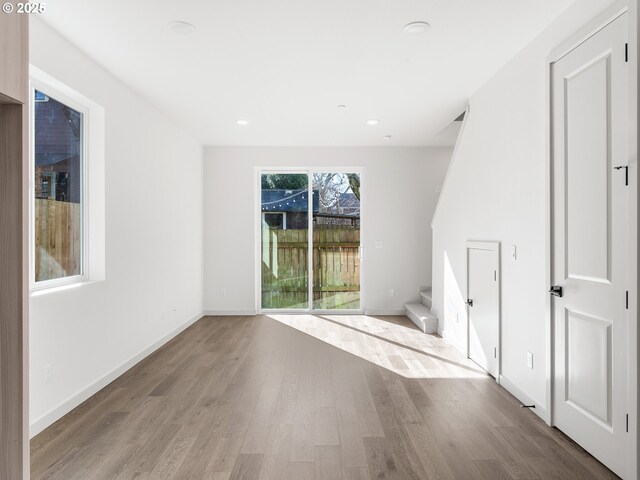 688 SE 47th Ave, Portland, OR 97215 - empty room with stairs, baseboards, wood finished floors, and recessed lighting