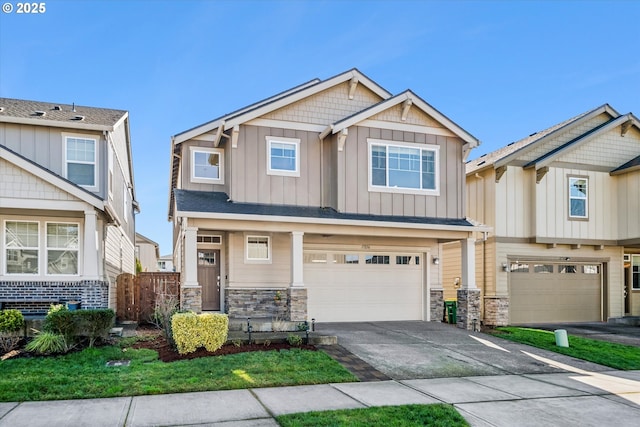 craftsman house featuring concrete driveway, an attached garage, board and batten siding, fence, and stone siding