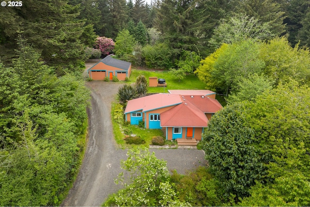 view of subject property with a forest