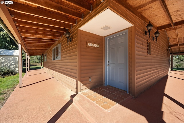 doorway to property with faux log siding