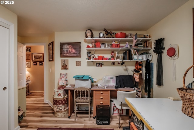 home office with light hardwood / wood-style flooring