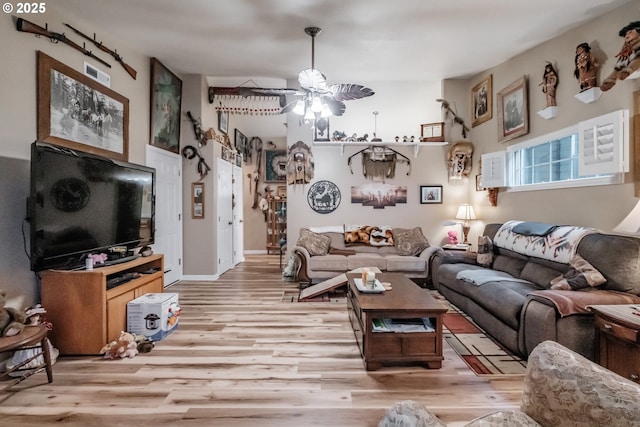 living room with ceiling fan and light hardwood / wood-style floors