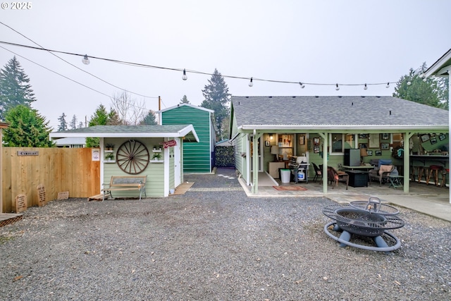 back of house featuring a fire pit