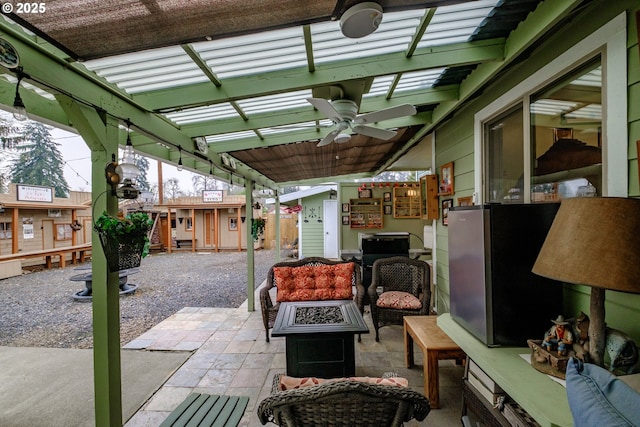 view of patio / terrace featuring an outdoor fire pit and ceiling fan