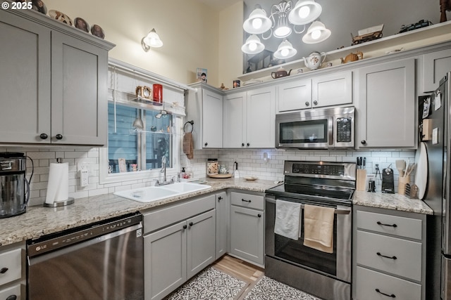 kitchen featuring decorative backsplash, appliances with stainless steel finishes, and sink