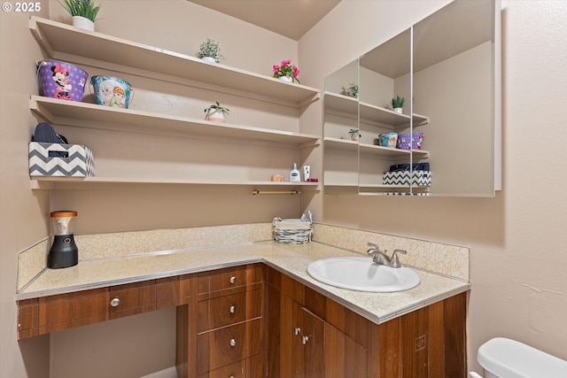 bathroom featuring vanity and toilet