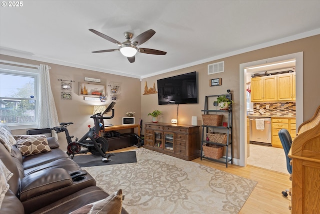 living room featuring crown molding, ceiling fan, and light hardwood / wood-style flooring