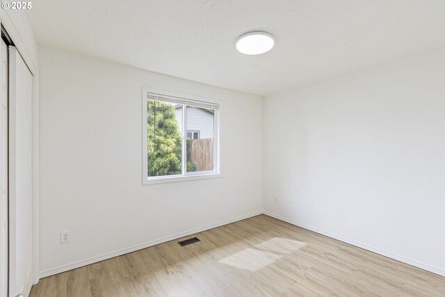 6253 SW 204th Pl, Beaverton, OR 97078 - unfurnished bedroom with multiple windows, light wood-style flooring, and a closet