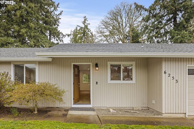 6253 SW 204th Pl, Beaverton, OR 97078 - property entrance with an attached garage, a shingled roof, and covered porch