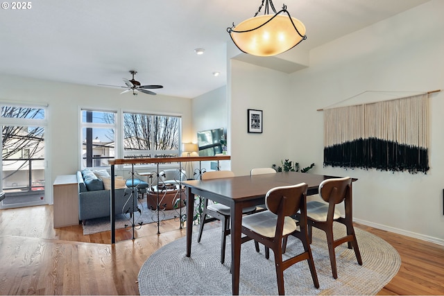 dining room with light wood-style floors, baseboards, a ceiling fan, and recessed lighting