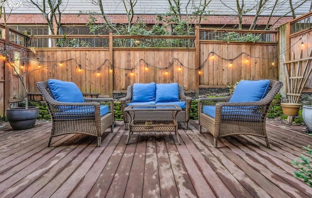 wooden terrace featuring outdoor lounge area and a fenced backyard