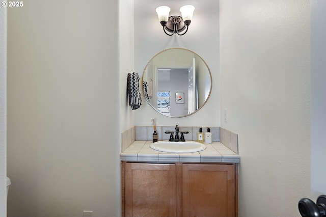 half bath with vanity and a notable chandelier