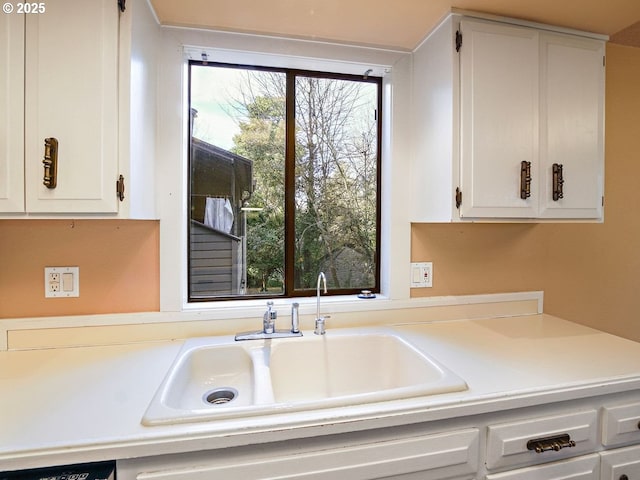 kitchen featuring sink and white cabinets