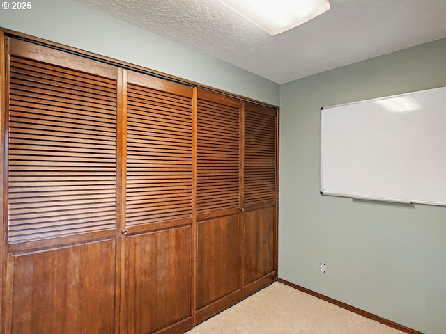 interior details featuring carpet and a textured ceiling