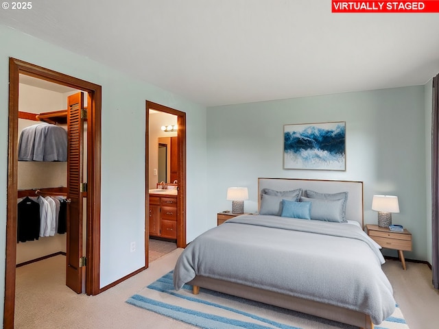 carpeted bedroom with ensuite bath, a spacious closet, and a closet