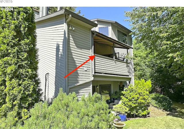 view of home's exterior with a balcony