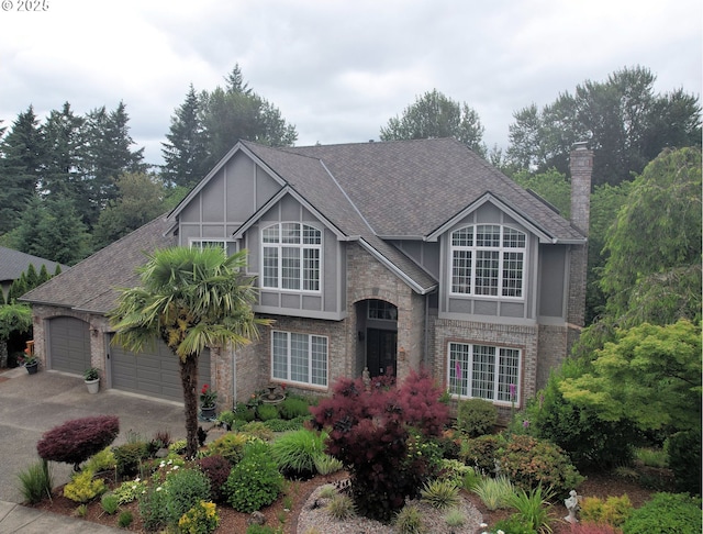 14995 SW Ashley Dr, Portland, OR 97224 - view of front of home with a garage, brick siding, driveway, roof with shingles, and board and batten siding
