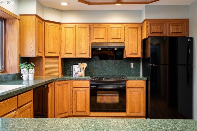kitchen featuring dark countertops, extractor fan, decorative backsplash, and black appliances