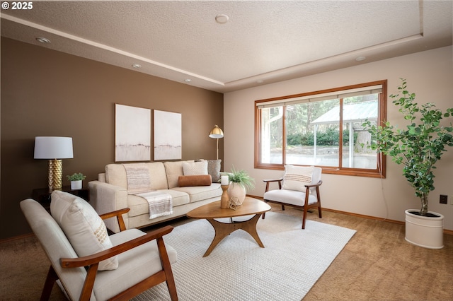 living area featuring recessed lighting, a textured ceiling, light carpet, and baseboards
