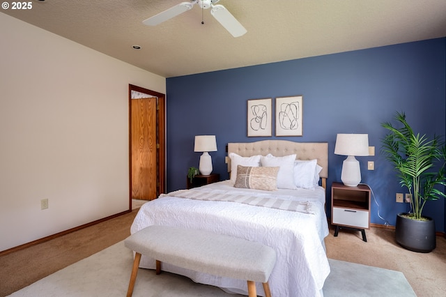 bedroom featuring baseboards, a ceiling fan, and carpet