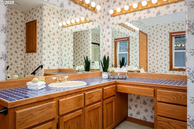 bathroom with tile patterned flooring, vanity, and wallpapered walls