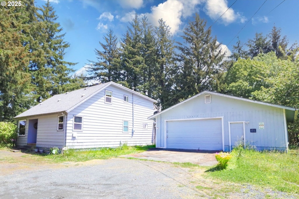 63673 Seven Devils Rd, Coos Bay, OR 97420 - view of side of property with a garage and an outbuilding