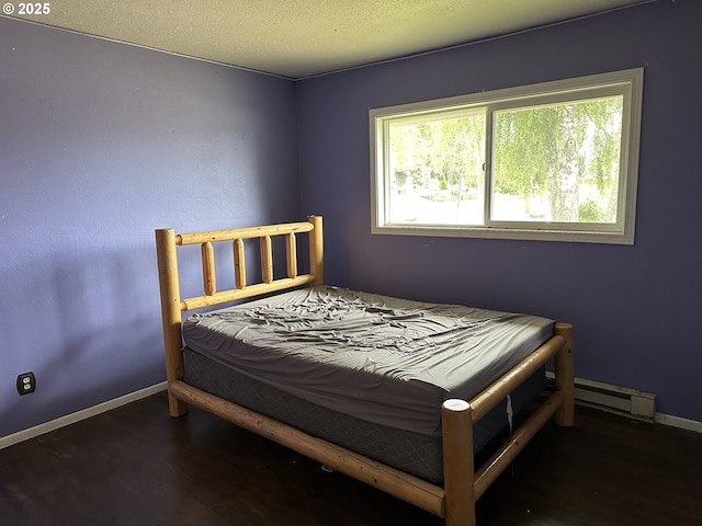 515 May St, Molalla, OR 97038 - bedroom with a baseboard radiator, wood finished floors, and baseboards