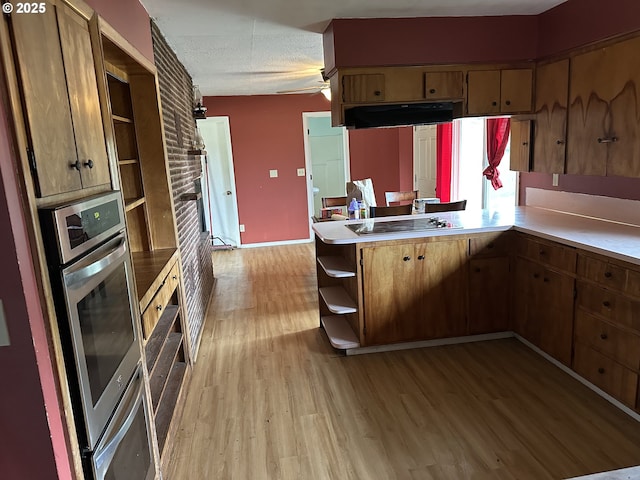 515 May St, Molalla, OR 97038 - kitchen with open shelves, light wood-style flooring, a peninsula, a textured ceiling, and light countertops