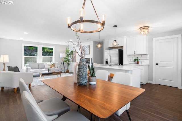 dining area featuring dark wood-style floors, baseboards, an inviting chandelier, and recessed lighting