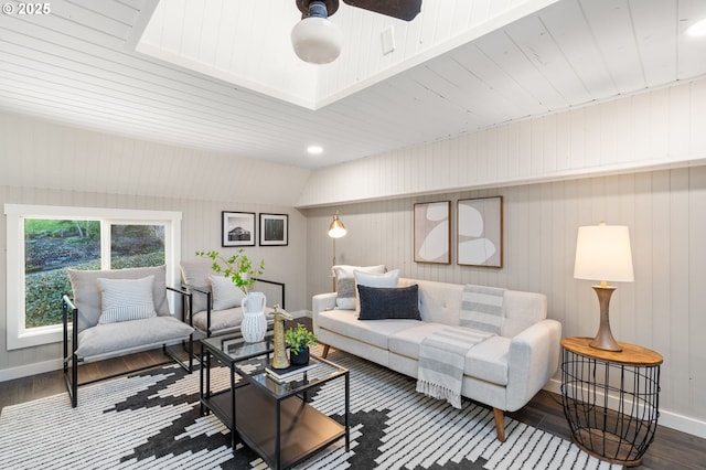 living room featuring ceiling fan, baseboards, and wood finished floors