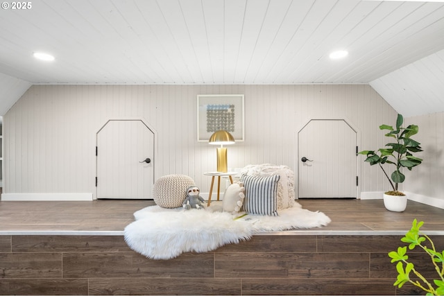 sitting room with vaulted ceiling, wood finished floors, and baseboards