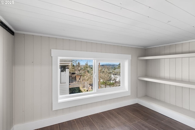 interior space with dark wood-type flooring and baseboards